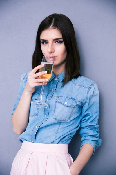 Cute young woman drinking champagne