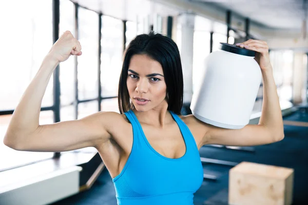 Fit woman showing her muscles