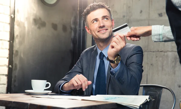 Man giving bank card to waiter