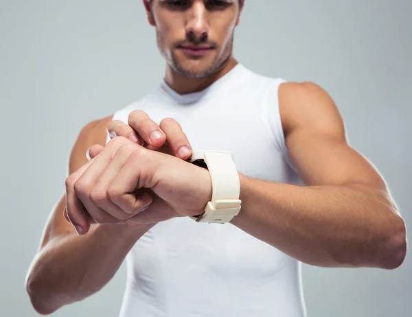 Fitness man using smartwatch