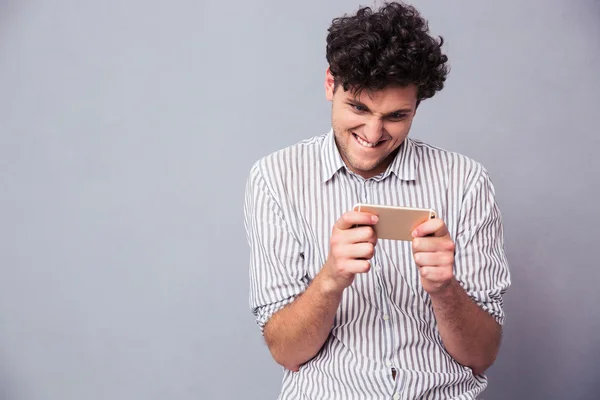 Man playing on smartphone