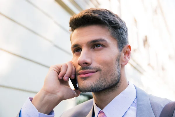 Happy businessman talking on the phone