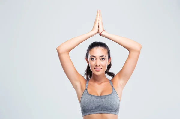 Fitness woman with joined hands over head