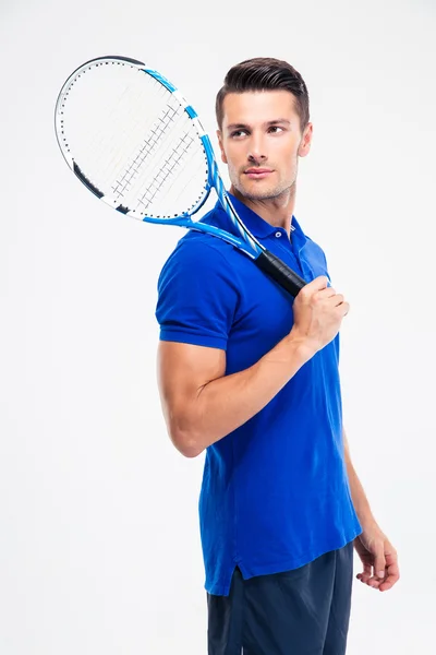 Pensive man in sports wear and tennis racket looking away