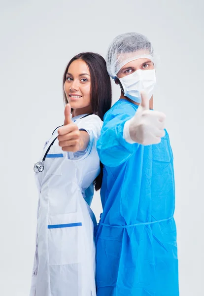 Portrait of a two medical workers showing thumbs up