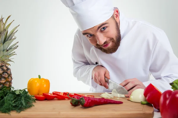 Male chef cook cutting vegetables