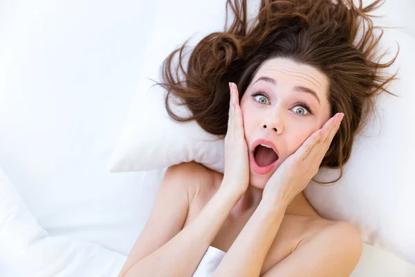 Shocked astonished woman wake up late in bed