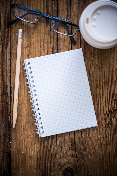 Empty note pad on desk with coffee