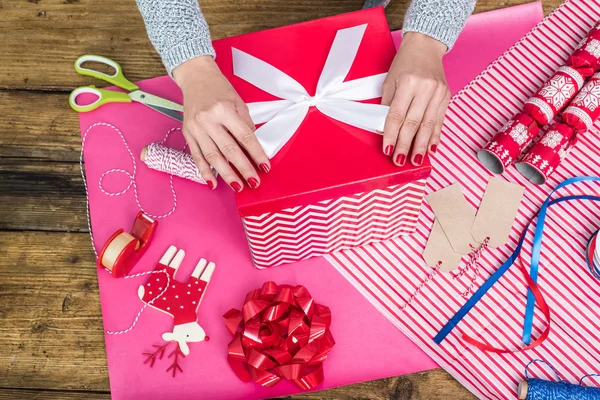 Woman hand wrap Christmas gift box