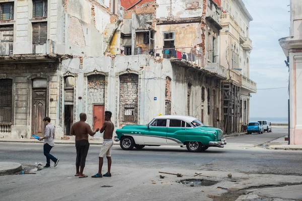 Cuban street scene with people and classic car