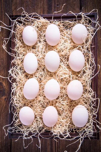 Dozen of farm fresh eggs in wooden crate