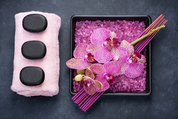 Spa set. Orchid, towel, zen stones and incense sticks on marble background