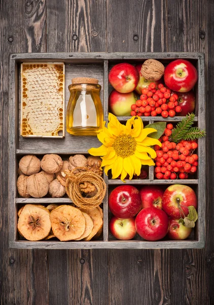 Autumn Collage in wooden box. Apples, honey, nuts, flowers sunflower