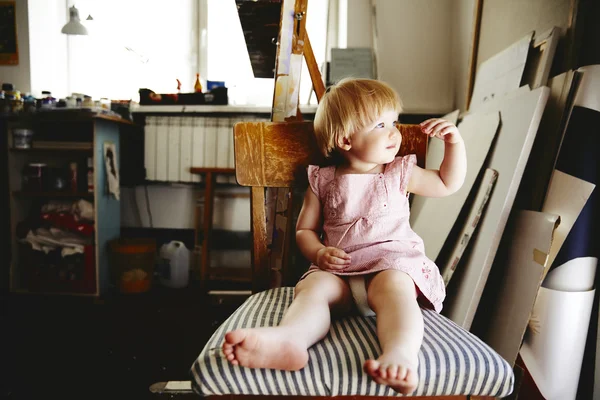 Baby girl sitting in art workshop
