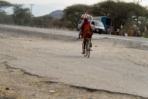 Masai tribal man on bike