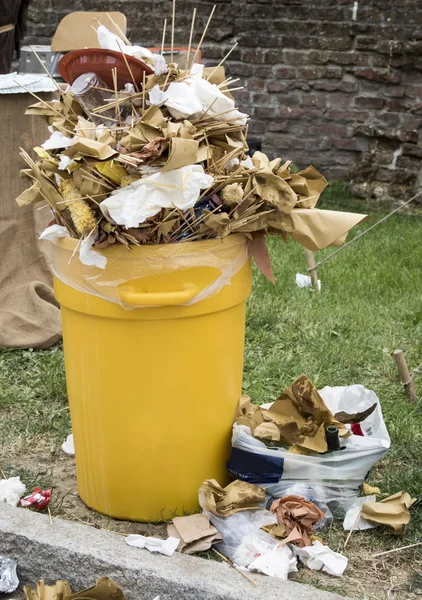 Overfull garbage can trash in festival