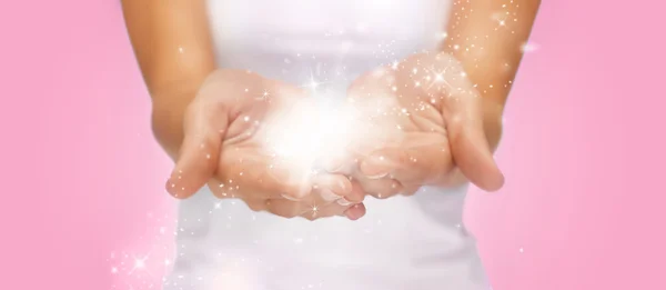 Magic twinkles or fairy dust on female hands