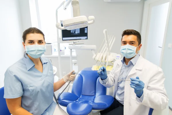 Close up of dentist and assistant at dental clinic
