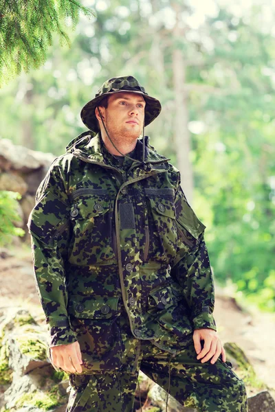 Young soldier or ranger in forest
