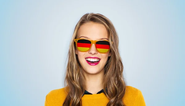 Happy young woman or teen girl in sunglasses