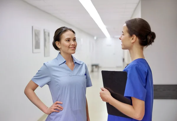 Medics, nurses or doctors talking at hospital