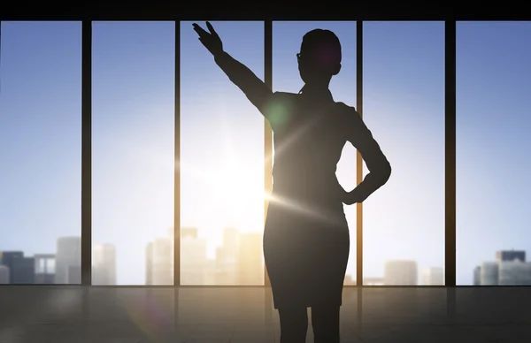 Silhouette of business woman pointing hand
