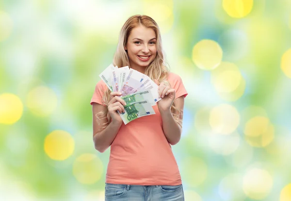 Happy young woman with euro cash money