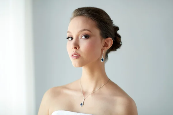 Beautiful asian woman with earring and pendant