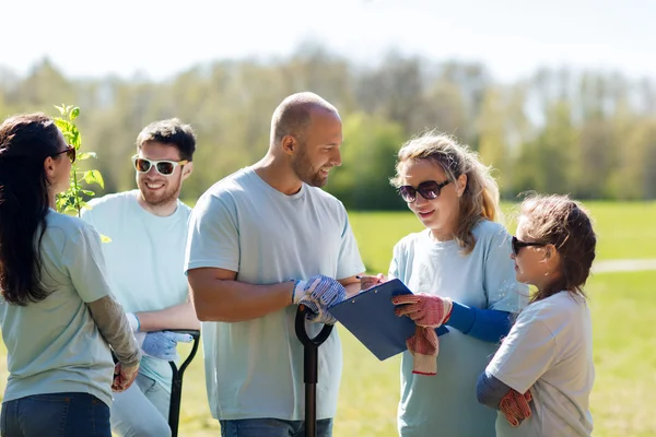 Group of volunteers planting trees in park