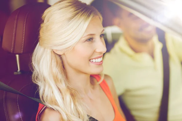 Happy man and woman driving car