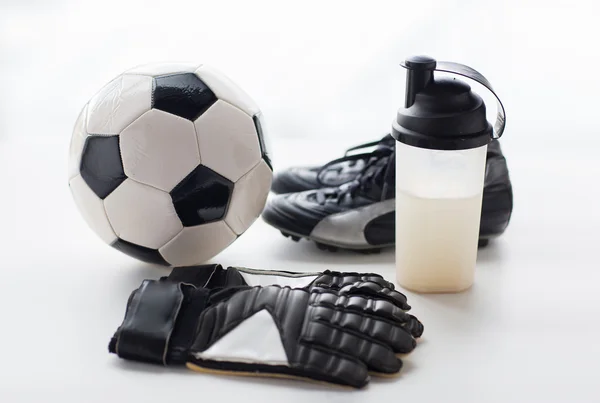 Close up of football boots, gloves and bottle