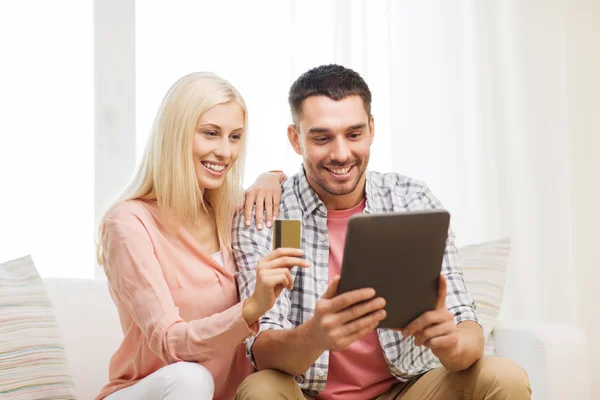 Happy couple with tablet pc and credit card