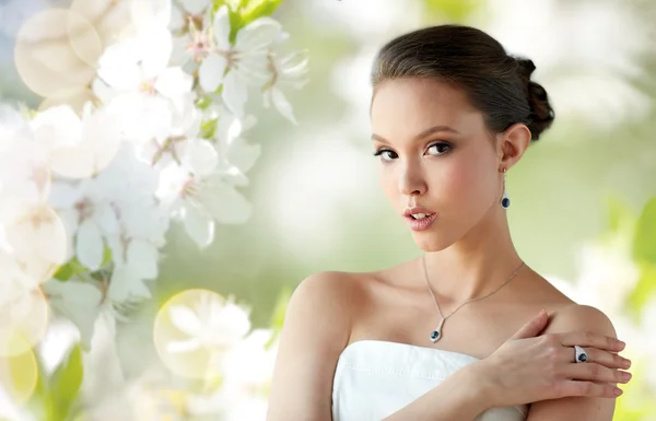 Beautiful woman with earring, ring and pendant