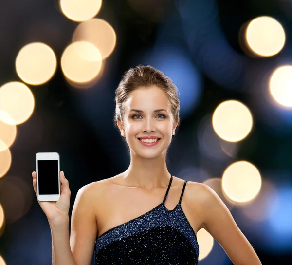 Smiling woman in evening dress with smartphone