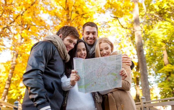 Group of friends with map outdoors