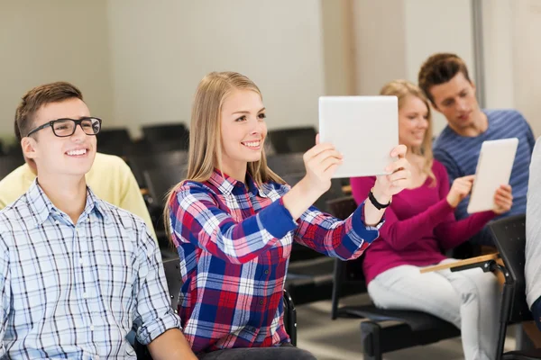 Group of smiling students with tablet pc