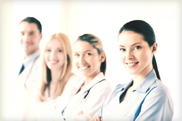 Female doctor in front of medical group