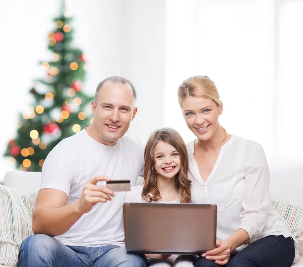 Happy family with laptop computer