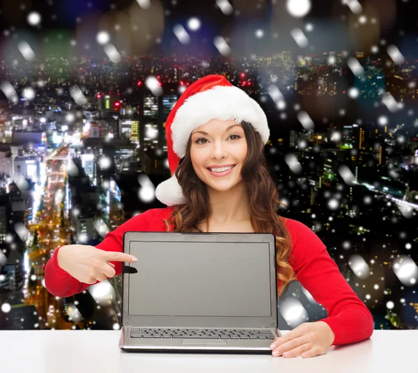 Smiling woman in santa helper hat with laptop