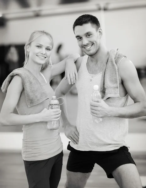 Two smiling people in the gym