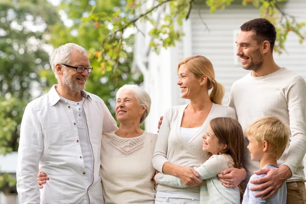 Happy family in front of house outdoors