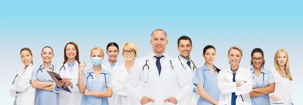 Group of smiling doctors with clipboard