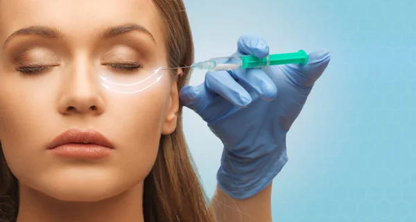Close up of woman face and hand with syringe