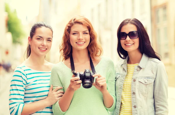 Smiling teenage girls with camera