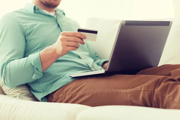 Close up of man with laptop and credit card