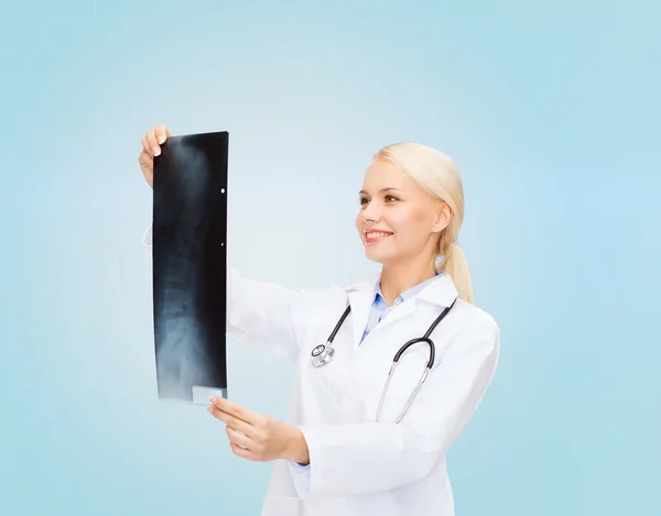 Smiling female doctor looking at x-ray image