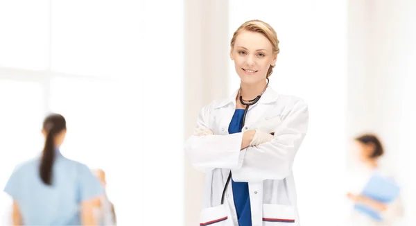 Smiling young female doctor in white coat