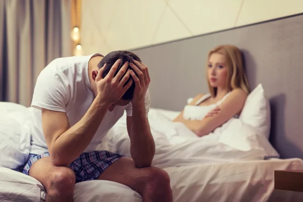 Man sitting on the bed with woman on the back