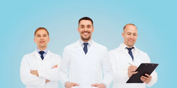 Group of smiling male doctors in white coats