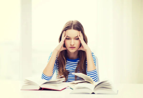 Stressed student girl with books